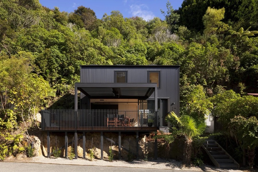 The award-winning Honeymoon Bay bach among native bush